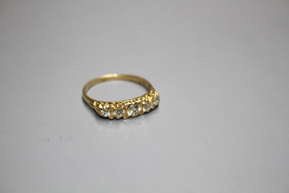 A modern 18ct gold and graduated five stone diamond half hoop ring,